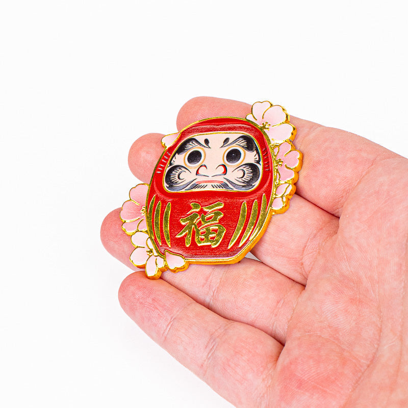 Japanischer Metallmagnet Daruma und Sakura